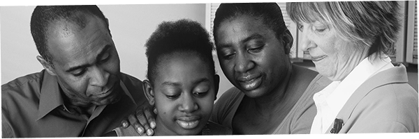 A family is comforted by a volunteer